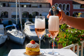 Summer party, drinking of French brut rose champagne sparkling wine in glasses in yacht harbour of Port Grimaud near Saint-Tropez, French Riviera vacation, France - obrazy, fototapety, plakaty