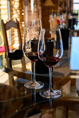Tasting of red dry wine in Chateauneuf-du-Pape wine making village in France with green vineyards on large pebbles galets and sandstone clay soil