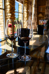 Tasting of red dry wine in Chateauneuf-du-Pape wine making village in France with green vineyards on large pebbles galets and sandstone clay soil