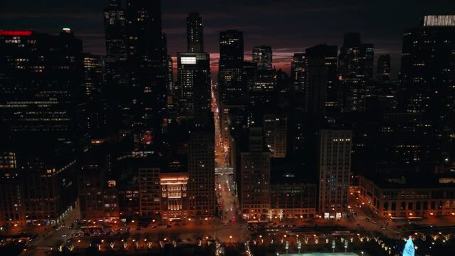Night street in Downtown Chicago skyscraper in the evening time. Aerial wide footage 
