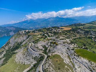 Aerial view on blue Lake of Serre-Poncon, reservoir border...