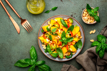 Spicy gourmet salad with sweet peach, hot jalapeno peppers, salted peanuts and green basil, green...