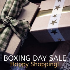 Composite of boxing day sale, happy shopping text over gift boxes