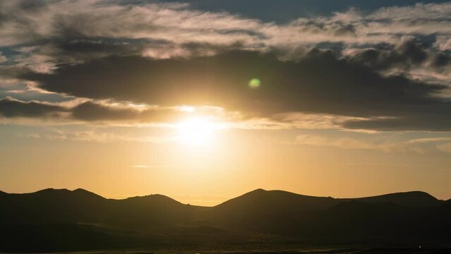 Timelapse of sun setting over distant desert horizon in Trona Pinnacles, California, USA