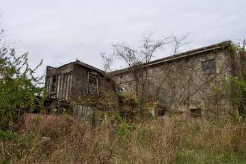 old abandoned falling down gas station building 