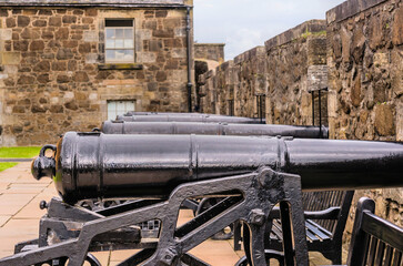 Fototapeta na wymiar Cannons mounted on metal cart on rampart of castle.