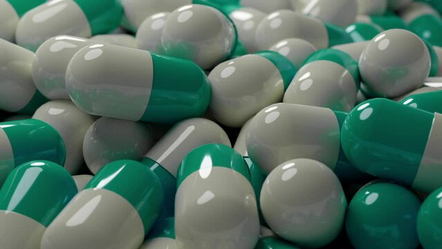 Mint green and white capsules on a conveyor