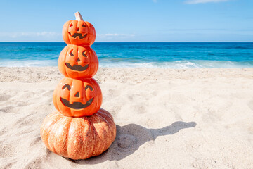 Happy Halloween beach background with four pumpkins