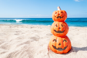 Halloween beach background with three smiling pumpkins - 664187701