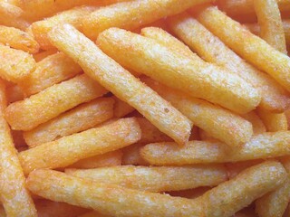 Abstract background of extruded snacks in stick form, shot at high angle