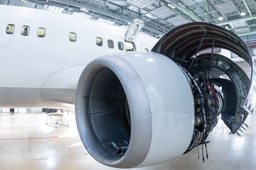 Close-up of an open high bypass turbofan airplane engine of a passenger aircraft in a hangar - obrazy, fototapety, plakaty