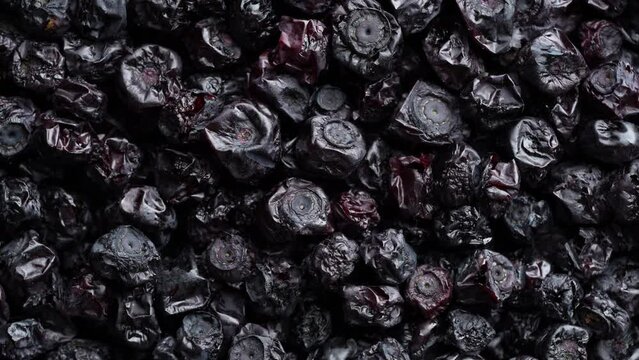 Dry wild blueberry in the background, rotating, close up, top view, macro. A way to preserve vitamins. Vegetarian meal, healthy and useful