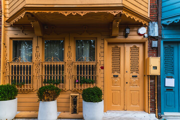 Yellow facade and entrance to a traditional wooden old house in Kuzguncuk district of Istanbul.