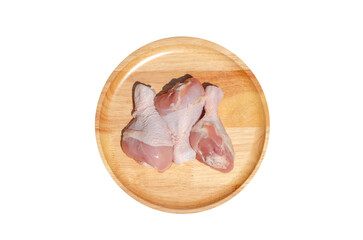 Raw fresh chicken wings or drumsticks chicken on a wooden plate. on transparent background.  Top...