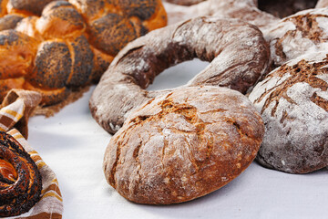 Different types of artisan craft bread in bakery store shelves