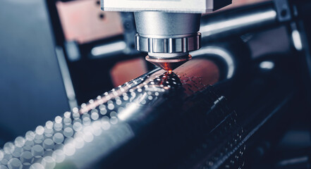 Macro CNC laser machine cutting sheet metal with light spark. Technology plasma industrial banner, Blue steel color.