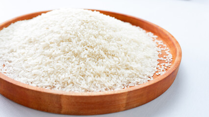 Fototapeta na wymiar photo of white rice on wooden tray, isolated on white background.