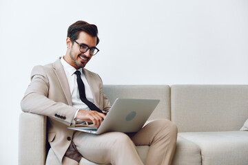 Man sofa video home couch indoors networking call online business smiling hunk computer laptop