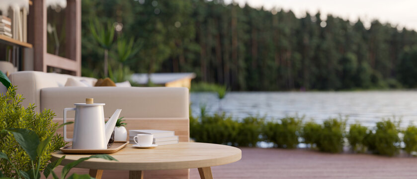 Side view of a wooden side table on a beautiful deck or terrace with a beautiful lake view.