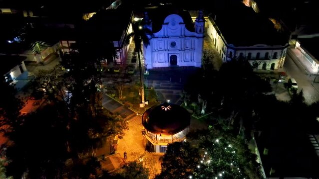 Aerial view over central park and catholic cathedral of Santa Rosa de Copan in Honduras during a night
