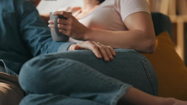 Loving Couple Talking Lying On Couch With Cup Tea Close Up. Family Time Together