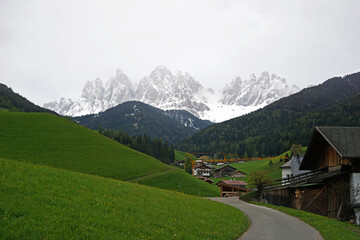 Fototapeta na wymiar Landscape of Santa Maddalena and exterior village buildings at Val di Funes, land of the pale mountains and beautiful valley in the Dolomites also one of UNESCO World Heritage site- South Tyrol, Italy