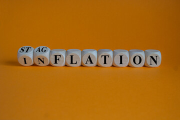 Stagflation or inflation symbol. Turned wooden cubes and changed the concept word inflation to...