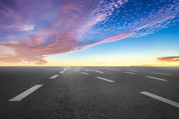 Empty asphalt road and sunset clouds background