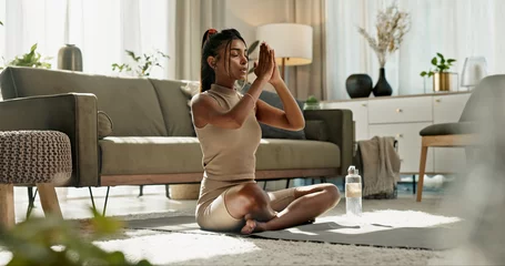 Tuinposter Woman, yoga and namaste on floor, peace or home for chakra balance, relax or breathing in living room. Girl, meditation and spiritual with zen, pilates or workout for wellness, fitness or mindfulness © N Felix/peopleimages.com