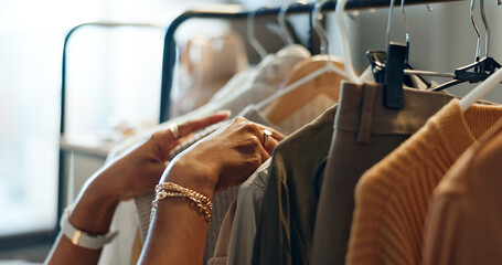 Hands of designer, clothes rail or choice in studio, workshop or small business for sample, show or...