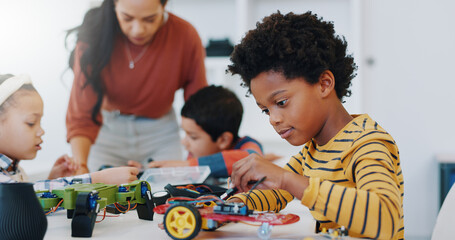 Technology, boy and car robotics at school for learning, education or electronics with car toys for innovation. Classroom, learners and transportation knowledge in science class for research or study © Clement C/peopleimages.com