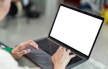 Woman working with modern laptop computer blank white desktop screen for advertising, mockup, technology, advertising, search information, creative design on table