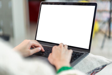 Woman working with modern laptop computer blank white desktop screen for advertising, mockup, technology, advertising, search information, creative design on table