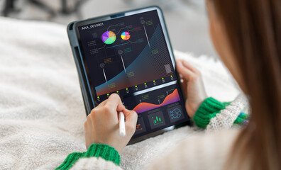 Analyst use laptop working with business analytics and data management system, make a report with KPI and metrics connected to database.Corporate strategy for finance, operations, sales, marketing