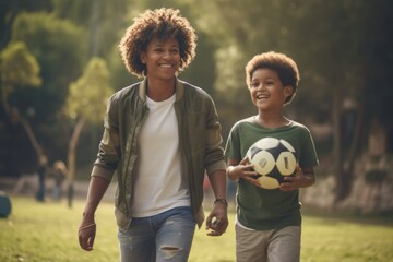 A mother and child walking in the park with a soccer ball. Fictional characters created by Generated AI. - obrazy, fototapety, plakaty