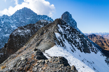 alpine rocky snowy mountains in Kazbegi, Georgia. hiking trekking adventure concept image.