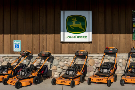 Scag walk behind mowers next to John Deere logo. Lynden, WA, USA - 13 November 2022