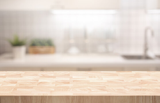 Selective focus.End grain wood counter,table top on blur kitchen counter in morning background.