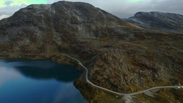 Aerial over the road and rugged landscape near Djupvattnet, Geiranger, Norway. Drone dolly forward shot