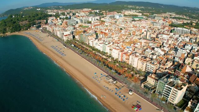 Aerial view, circular flight control of Lloret De Mar beach on the Costa Brava of Gerona, few people on the beach