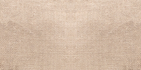 Fototapeta na wymiar Jute hessian sackcloth woven organic burlap, hemp flax texture pattern background in light cream yellow beige brown color