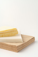 Beige paper napkins on white background studio shot