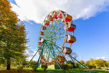 Ferris wheel in the city park on a warm sunny autumn day