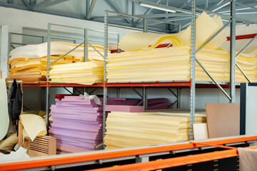 Stacked sheets of foam rubber for furniture production in factory workshop