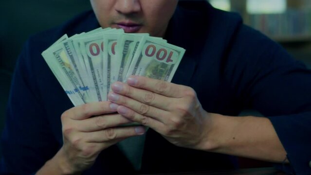 Happy asian man with dollar bills, trade concept.