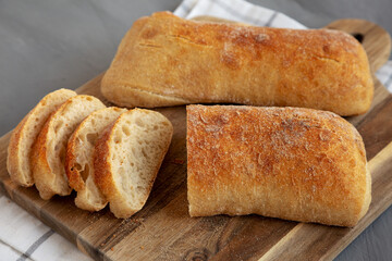 Homemade Ciabatta Bread on a wooden board, side view.