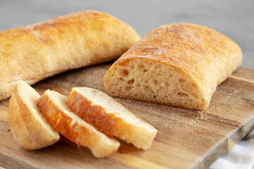 Homemade Ciabatta Bread on a wooden board, side view.