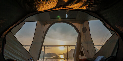 Picture taken from inside the tent to Landscape on the mountain on sea at Samet Nangshe Viewpoint in sunrise. Unseen place of Samet Nangchee in Phang Nga province, Thailand. © SandyHappy