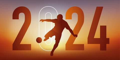 Concept du sport sur le thème du football pour une carte de vœux 2024, montrant un footballeur qui frappe le ballon du pied pour marquer un but. - 664263374