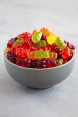 Colorful Fruity Gummy Bears in a Bowl, side view.